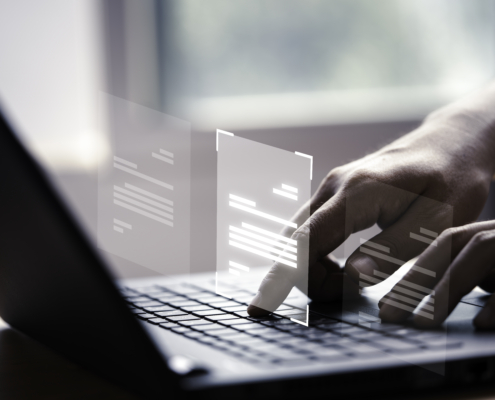 Hand using laptop computer with virtual screen and document for online approve paperless quality assurance and ERP management concept.